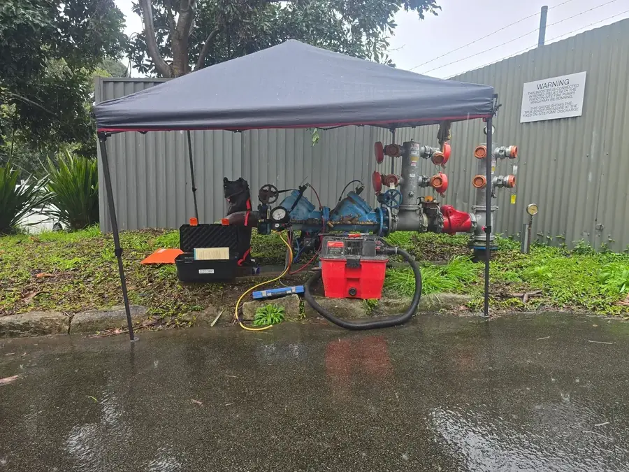 Backflow testing set-up under a gazebo beside valves on a site