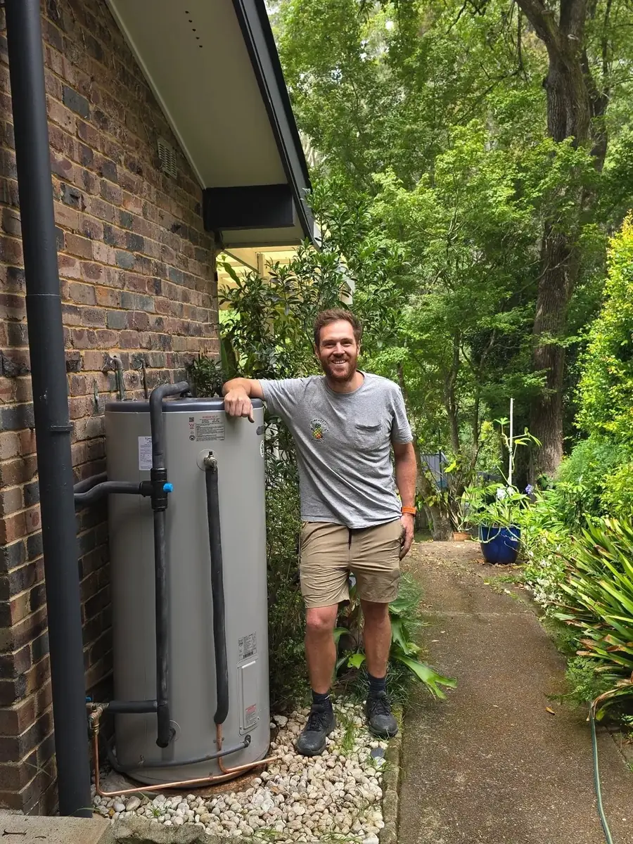 Danny, Director of Pineapple Plumbing co. Sydney, with a hot water system on site